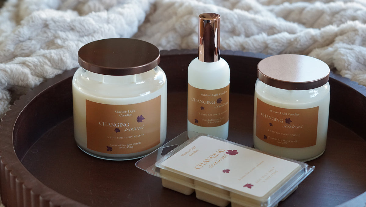 Pictures is a 16 oz candle with a yellow label named changing seasons, a 9 oz candle with a yellow label named changing seasons a wax melt and room spray all from the same collection and same design 