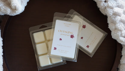 Changing Seasons Wax Melt. Yellow wording with leaves on label. 
