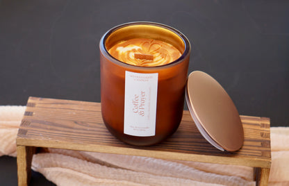 Candle with a label on a wooden stand against a dark background
