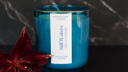 Blue candle with a label on a dark background