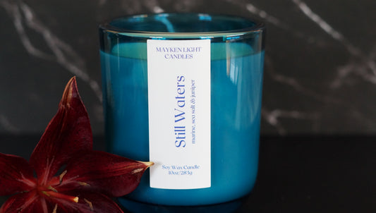 Blue candle with a label on a dark background
