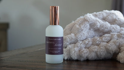 White Bottle with rose gold lid with a burgundy label showing Faithful Harvest 100 ml room spray