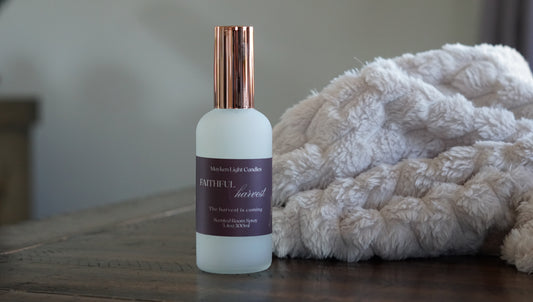 White Bottle with rose gold lid with a burgundy label showing Faithful Harvest 100 ml room spray