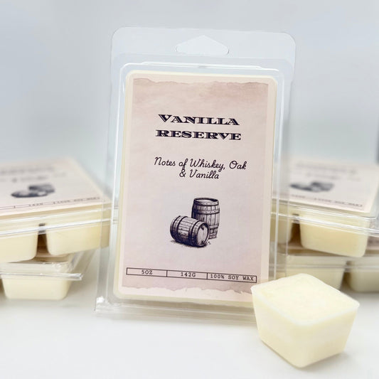 Packaged vanilla scented wax melts with a label indicating the scent and the inclusion of whiskey, oak, and vanilla.