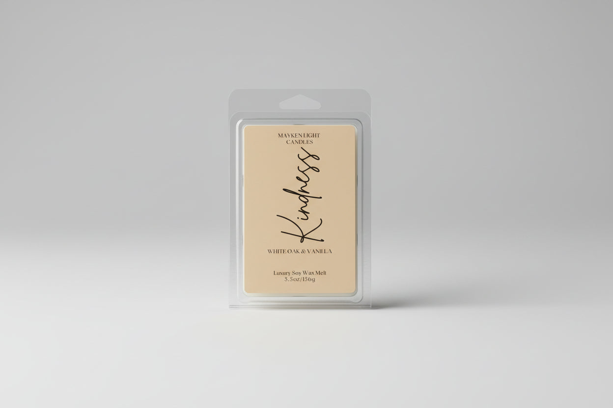 Wax melt packaging with 'Kindness' text on a marble background