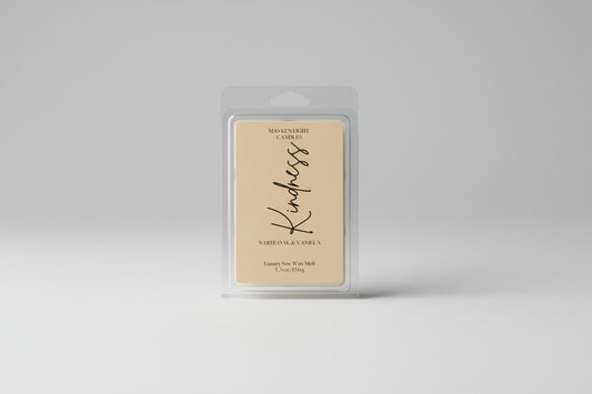 Wax melt packaging with 'Kindness' text on a marble background