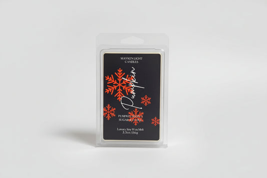 Two wax melt packages with snowflake design on a marble surface