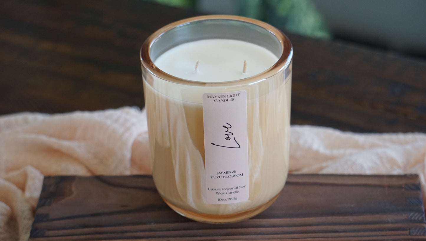 Candle with a label on a wooden surface