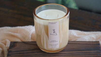 Candle with a label on a wooden surface