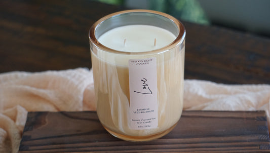 Candle with a label on a wooden surface