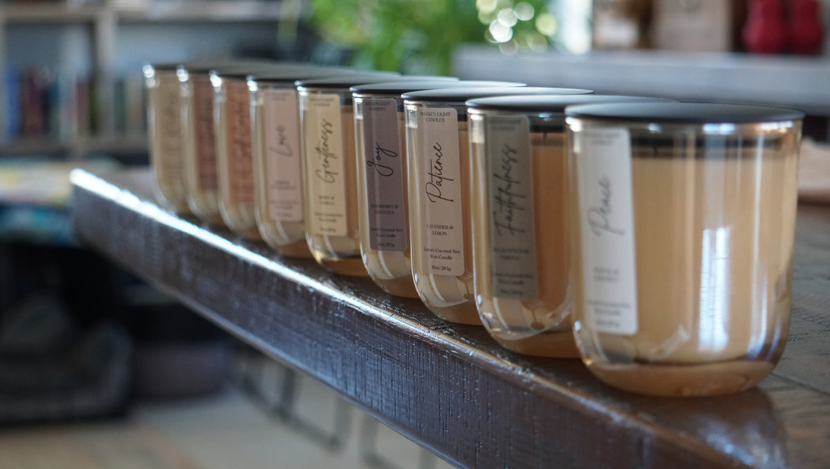 Row of candles with labels on a shelf in a store setting