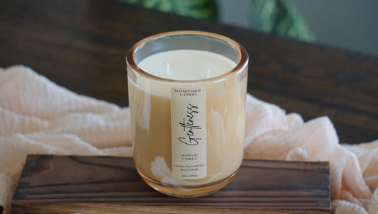 Candle with a label on a wooden surface