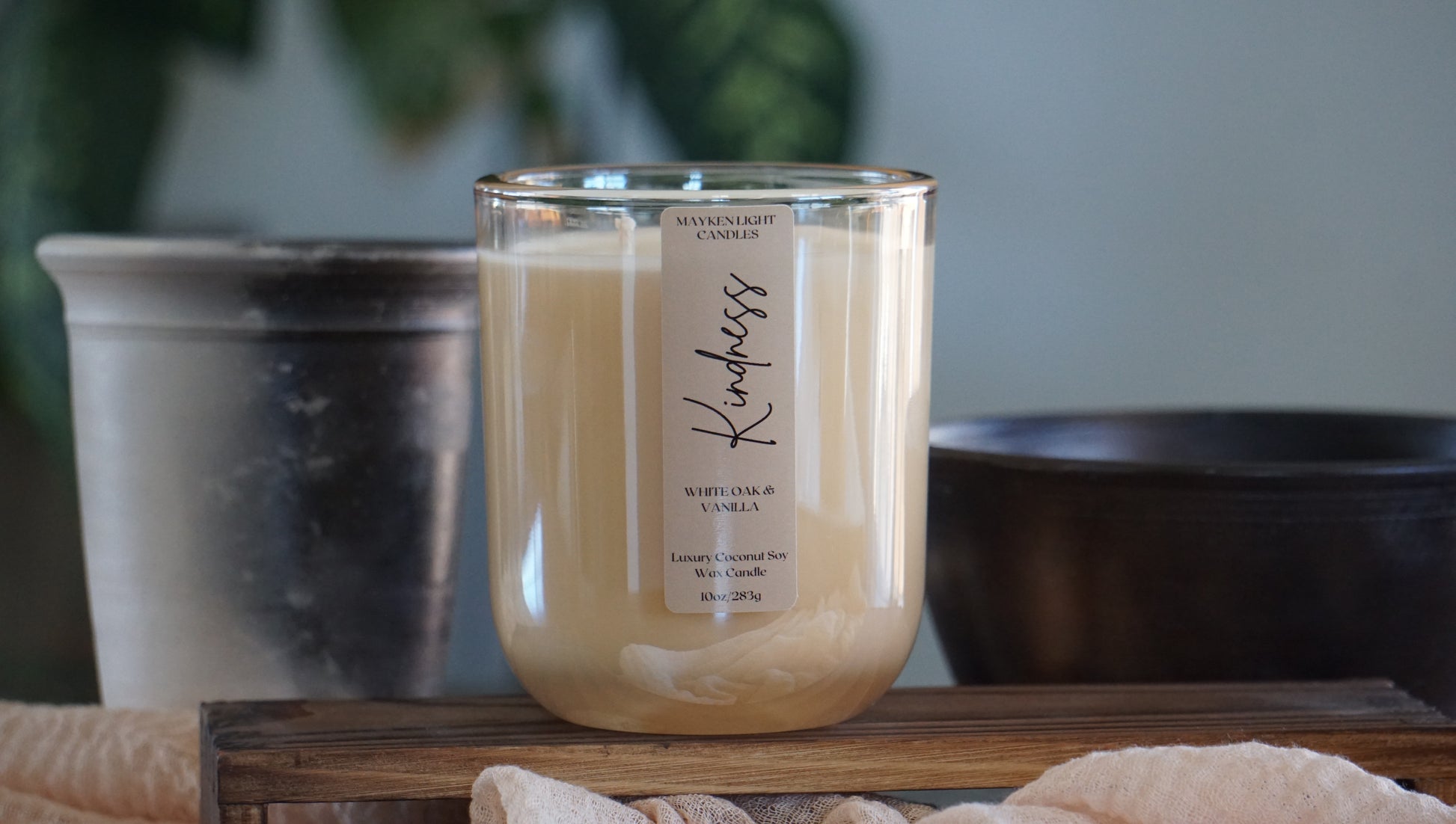 Candle with a label on a wooden surface with a blurred background