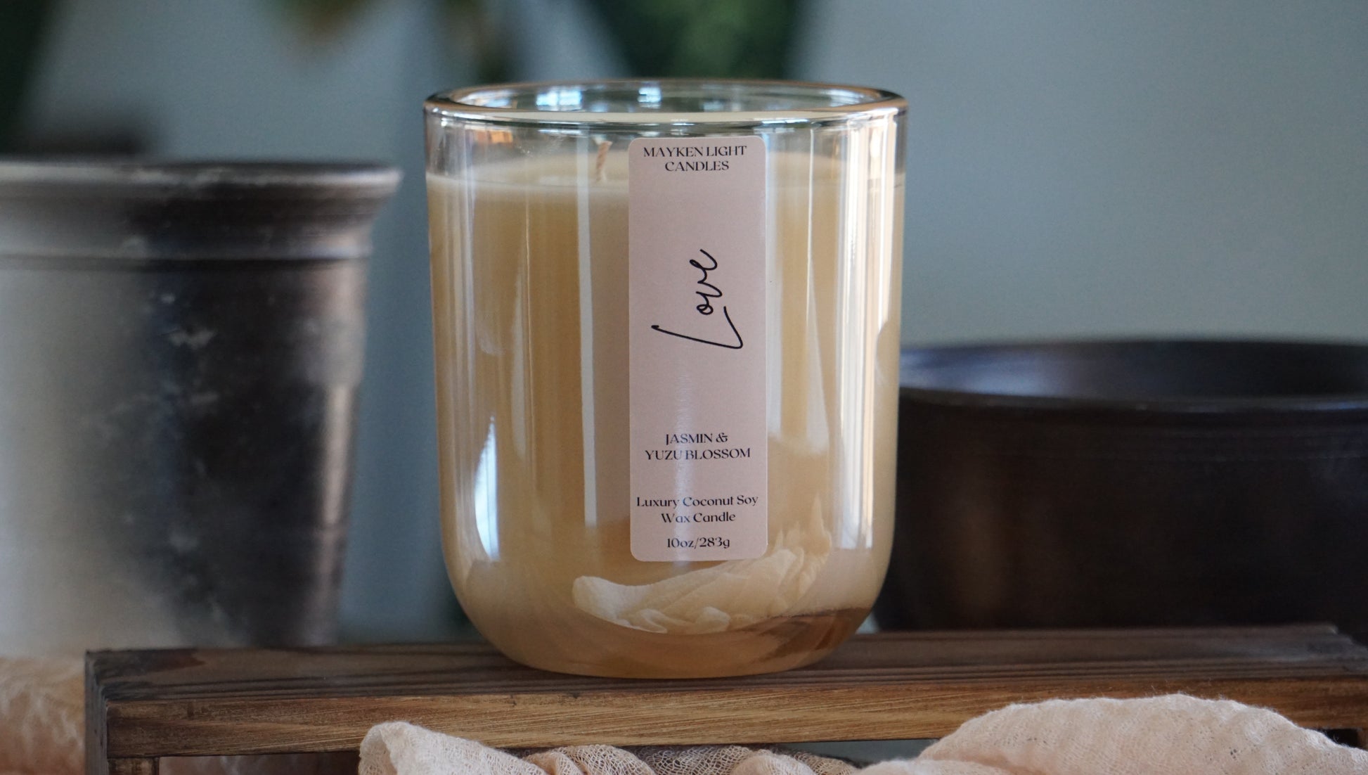 Candle with a label on a wooden surface