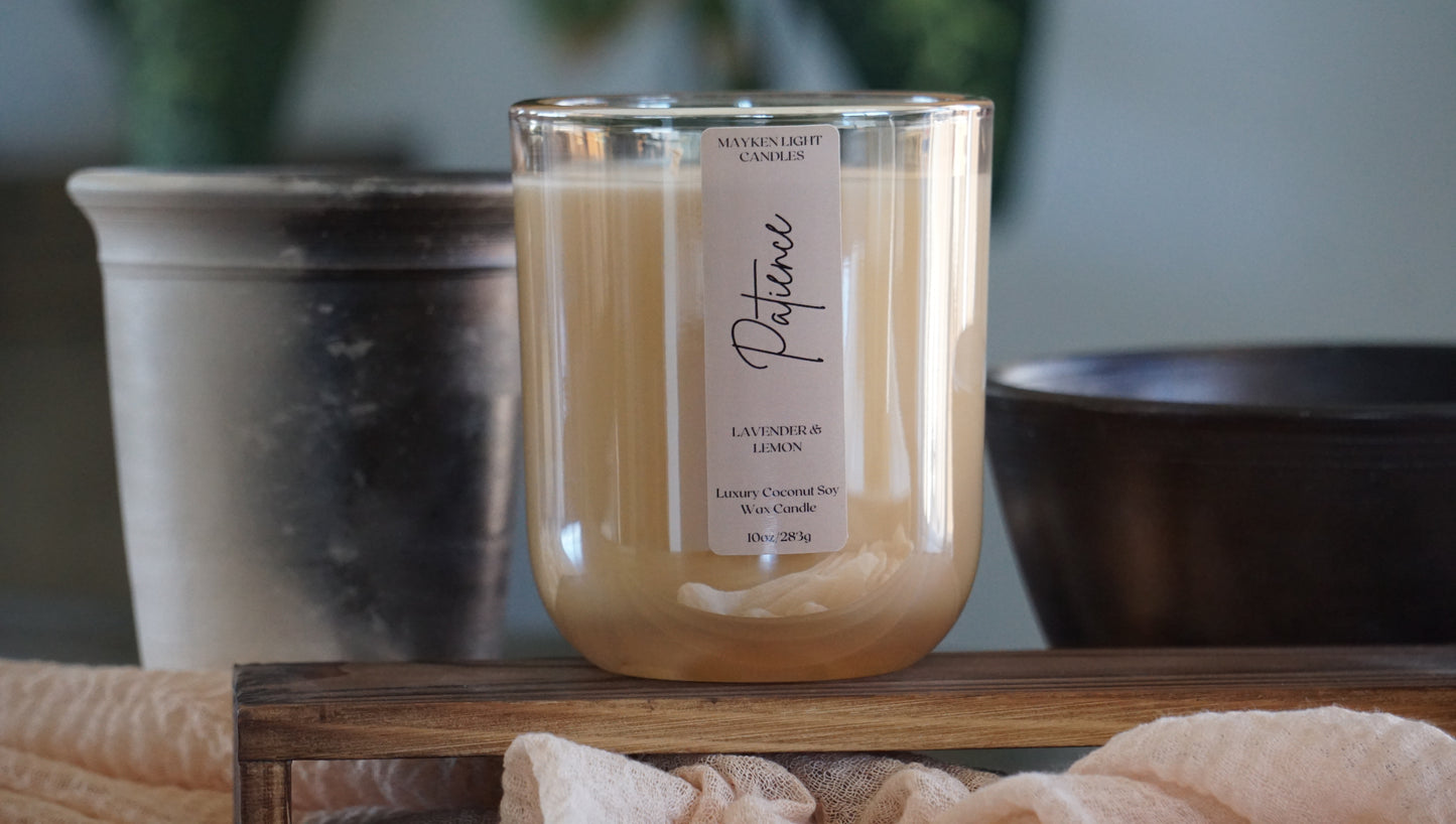 Candle with a label on a wooden surface with a blurred background